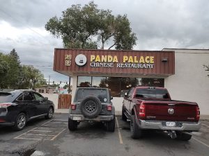 Chinese restaurant front in Black Canyon Of The Gunnison National Park parking area with several parked vehicles.