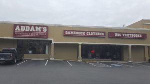 Gift shop storefront in Congaree National Park offering park-themed apparel and supplies in a strip-mall style building.