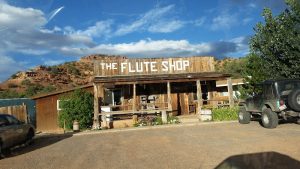 Trading post storefront at Capitol Reef National Park, a weathered wooden building beside a dirt lot.