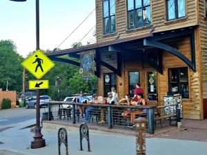 Outdoor seating along a rustic wooden storefront in Ridgway, near Black Canyon of the Gunnison National Park.