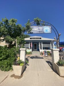 Bakery and cafe near the Carlsbad Caverns National Park entrance, shown under a decorative arch with greenery.