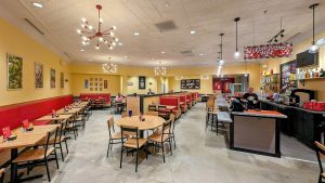 Indoor dining area of a restaurant at Congaree National Park, with yellow walls, red booths, and wooden tables.