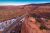 A winding road cuts through red sandstone cliffs in Arches National Park near Moab, Utah.