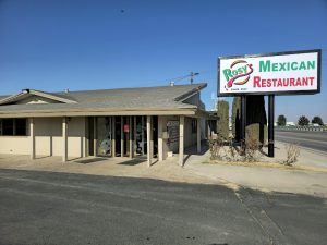 Mexican restaurant beside the Carlsbad Caverns National Park entrance, a single-story beige building with a large roadside sign.