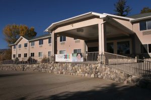 Lodging building in Cedaredge beside Black Canyon of the Gunnison National Park, with a stone retaining wall.