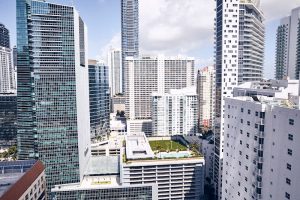 Downtown Miami skyline viewed from a high-rise near Biscayne National Park, with glass towers and blue sky.