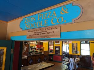 Inside Zion National Park, a colorful casual dining hall offering pizza and noodles inside a whimsical restaurant.