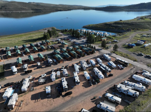 Panguitch Lake in Bryce Canyon National Park with a campground and RVs along the shore and a calm blue lake.