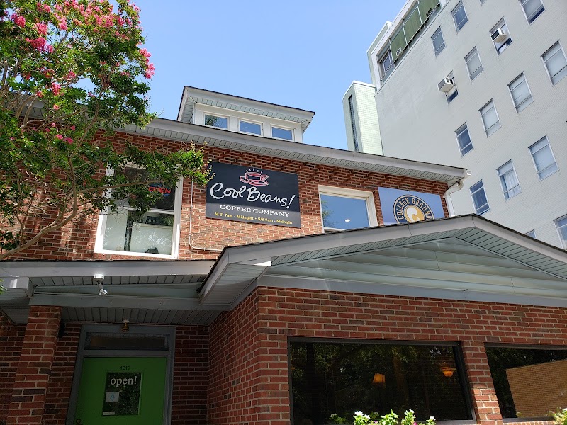 Brick coffee shop with green door and flowering tree in Whitefish Montana