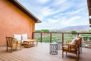 Hotel balcony terrace on a spacious deck overlooking Capitol Reef National Park's desert landscape.