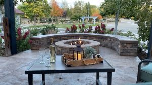 Patio with a stone fire pit and tables at a park gift shop, featuring wine and candles in Black Canyon of the Gunnison National Park.