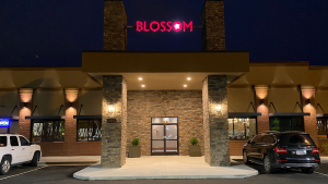 Front entrance of a park-area restaurant in Congaree National Park at night, lit by warm exterior lights.