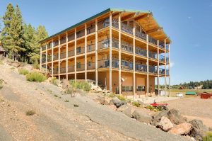 Duck Creek Lodge rises on a rocky slope with multiple wooden decks overlooking Bryce Canyon National Park.