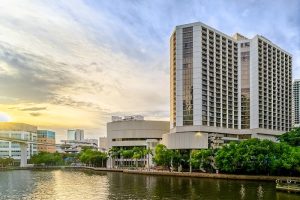 Waterfront hotel along Biscayne Bay in downtown Miami near Biscayne National Park with the city skyline reflected in the water.
