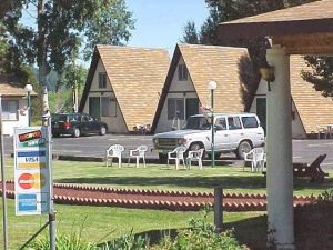 A-frame lodge buildings and parked cars at Crater Lake National Park lodging area.