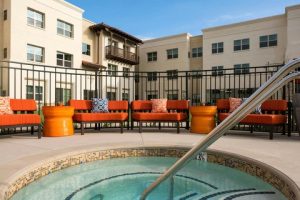 Outdoor hotel pool area with bright orange seating at a Santa Barbara Goleta property near Channel Islands National Park.