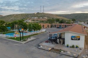 Lodging complex in Whites City near Carlsbad Caverns National Park, with a single-story building and parking lot.