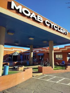 Gift shop at Canyonlands National Park with orange adobe-style exterior and blue overhead canopy.