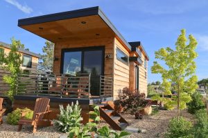 Escalante Escapes lodging cabin in Capitol Reef National Park with a wooden exterior, deck, and desert landscaping.