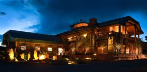 Resort-style lodge sits along stone terraces in Capitol Reef National Park, glowing warmly at dusk without naming the property.