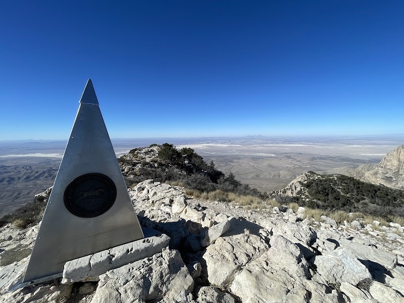 Guadalupe Peak Summit marker with sweeping desert valley views above Carlsbad Caverns National Park.