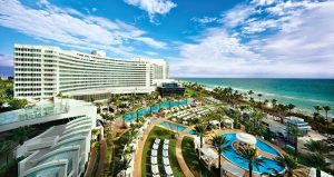 Oceanfront hotel and pool complex along Biscayne National Park coast with palm-lined terraces and blue ocean views.