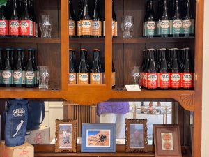 Capitol Reef National Park cidery taproom shelves with bottled beverages on wooden racks.