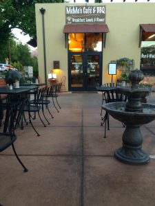 Outdoor seating outside a café at Zion National Park, with warm lights through the windows.
