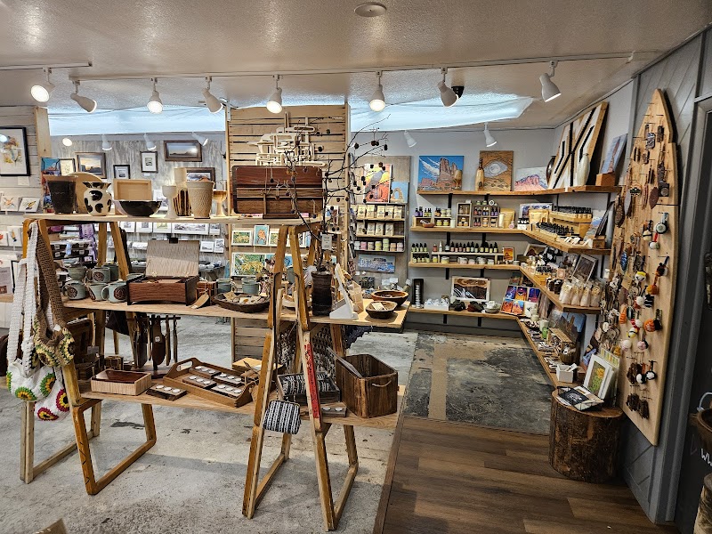 Arches National Park gift shop interior with wooden displays of pottery, paintings, jewelry, and souvenirs.