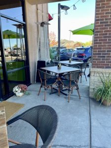 Outdoor dining patio at a restaurant in Black Canyon Of The Gunnison National Park, with tables, chairs, and a heater.