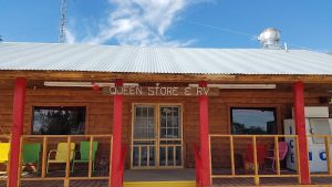 Store and RV park building at Carlsbad Caverns National Park, wooden facade with colorful chairs on the porch.