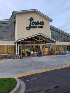 Forest Acres Lowe's Foods exterior storefront near Congaree National Park, beige siding with large glass windows and green trim.