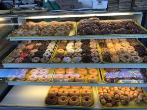 Bakery display case with assorted donuts at a cafe inside Black Canyon of the Gunnison National Park, near Montrose Donut and Deli