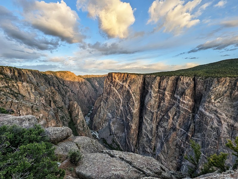 Deep cliff walls of Black Canyon plunge from the Chasm View overlook at Black Canyon Of The Gunnison National Park.