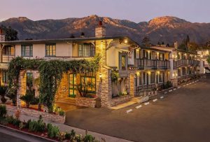 Exterior of a Santa Barbara lodging property with mountain backdrop near Channel Islands National Park.