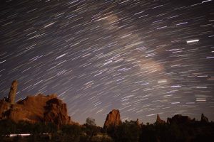 Star trails streak across the night sky above rock formations near Kodachrome Basin Visitor Center in Bryce Canyon National Park