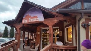 Rustic wooden gift shop exterior with a covered porch in Zion National Park, inviting visitors to the canyon area.