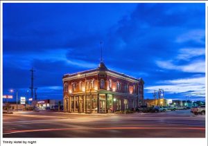 Historic brick hotel building lit at night in Carlsbad Caverns National Park near the town center.