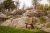 Photograph of landscape with large boulders and rock sculptures.