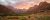 The sun sets behind large red and white towers of sandstone.