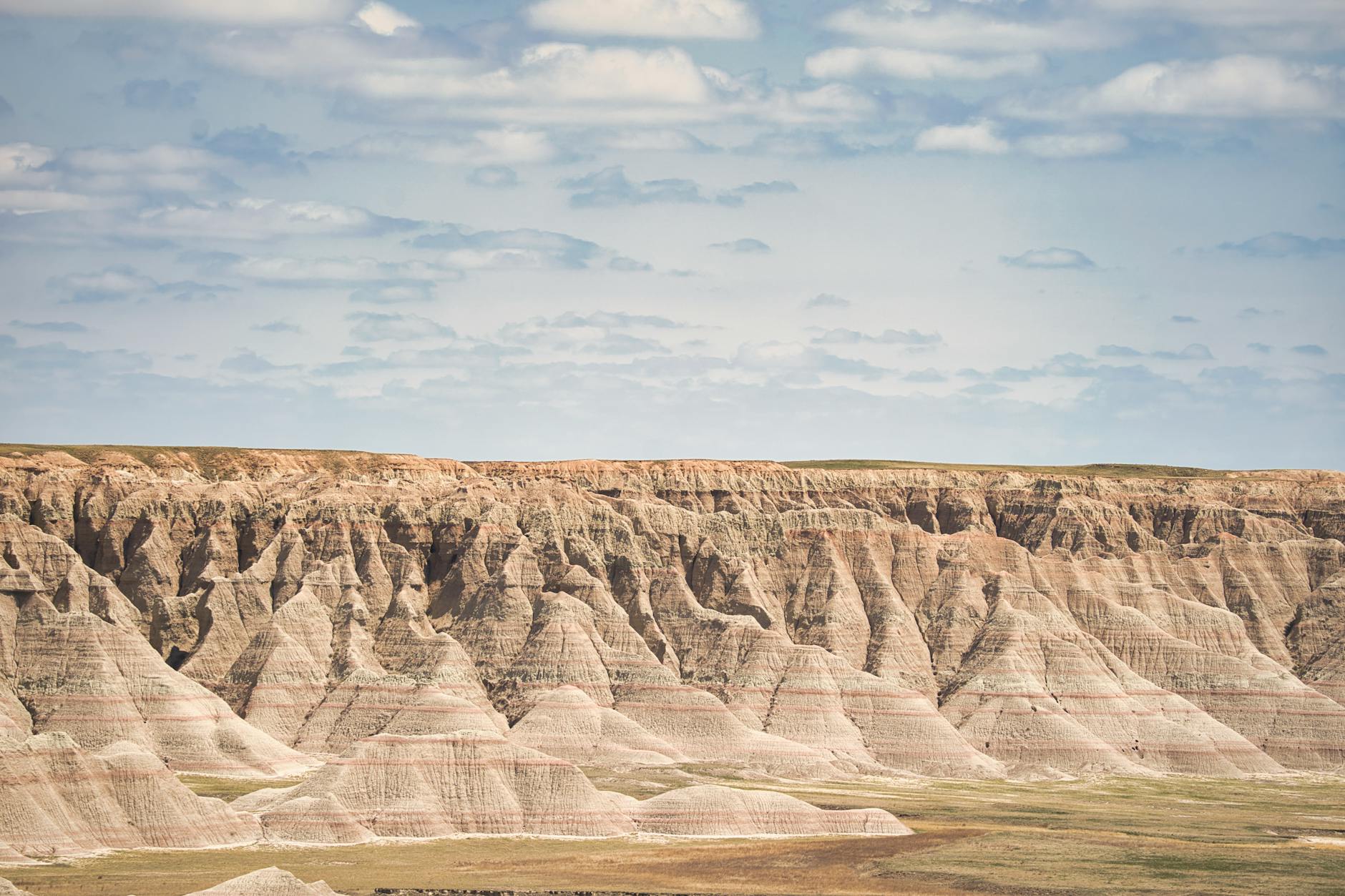Breathtaking view of the eroded rock formations in Badlands National Park under a bright sky.