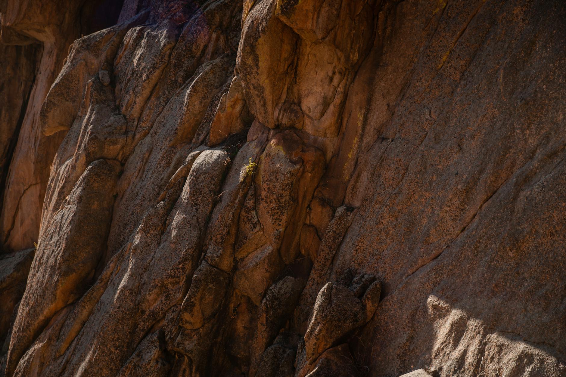 Detailed texture of a rugged rock formation showing erosion and geological patterns.