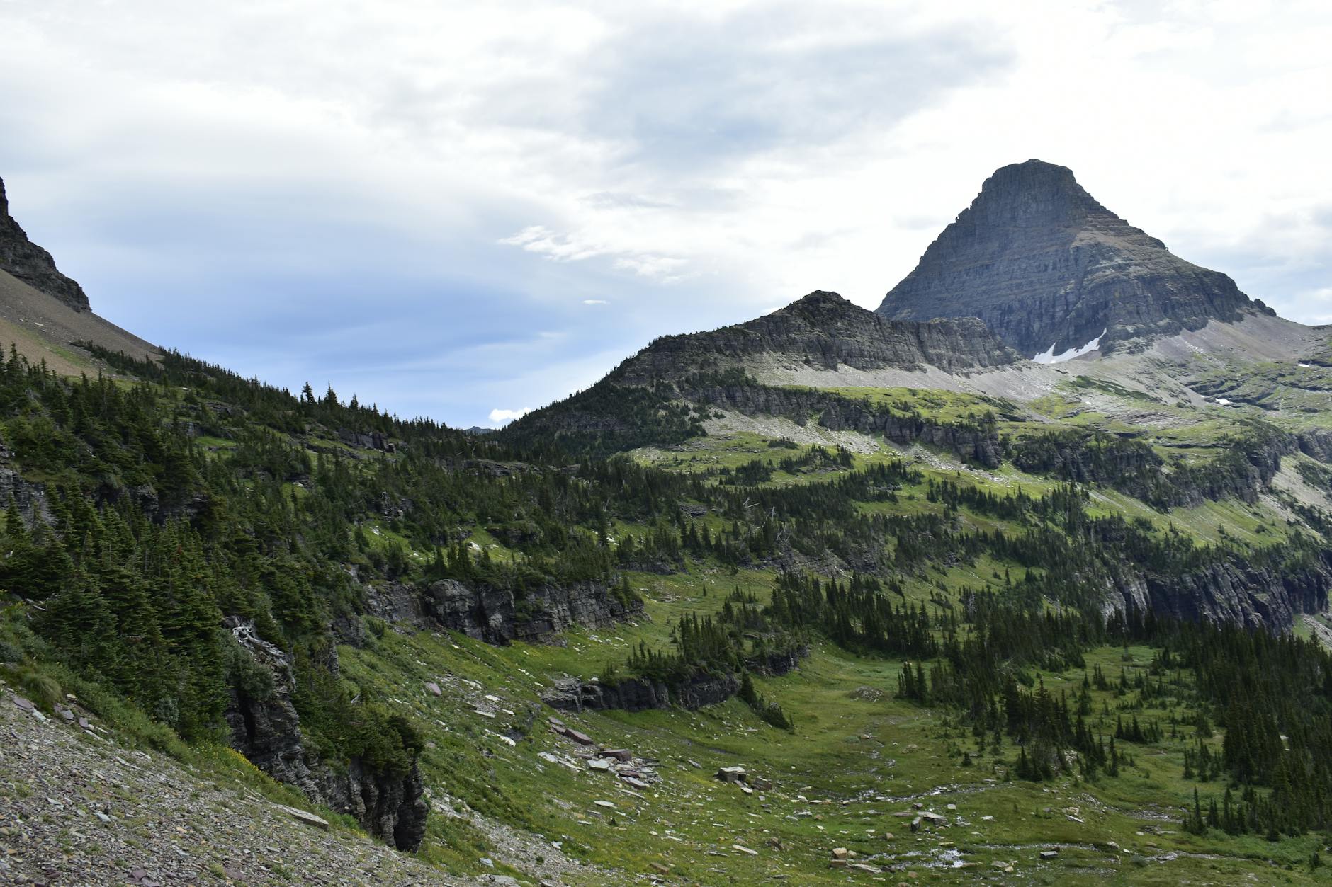Breathtaking view of a rugged mountain peak in Glacier National Park, Montana, captured on a summer day.