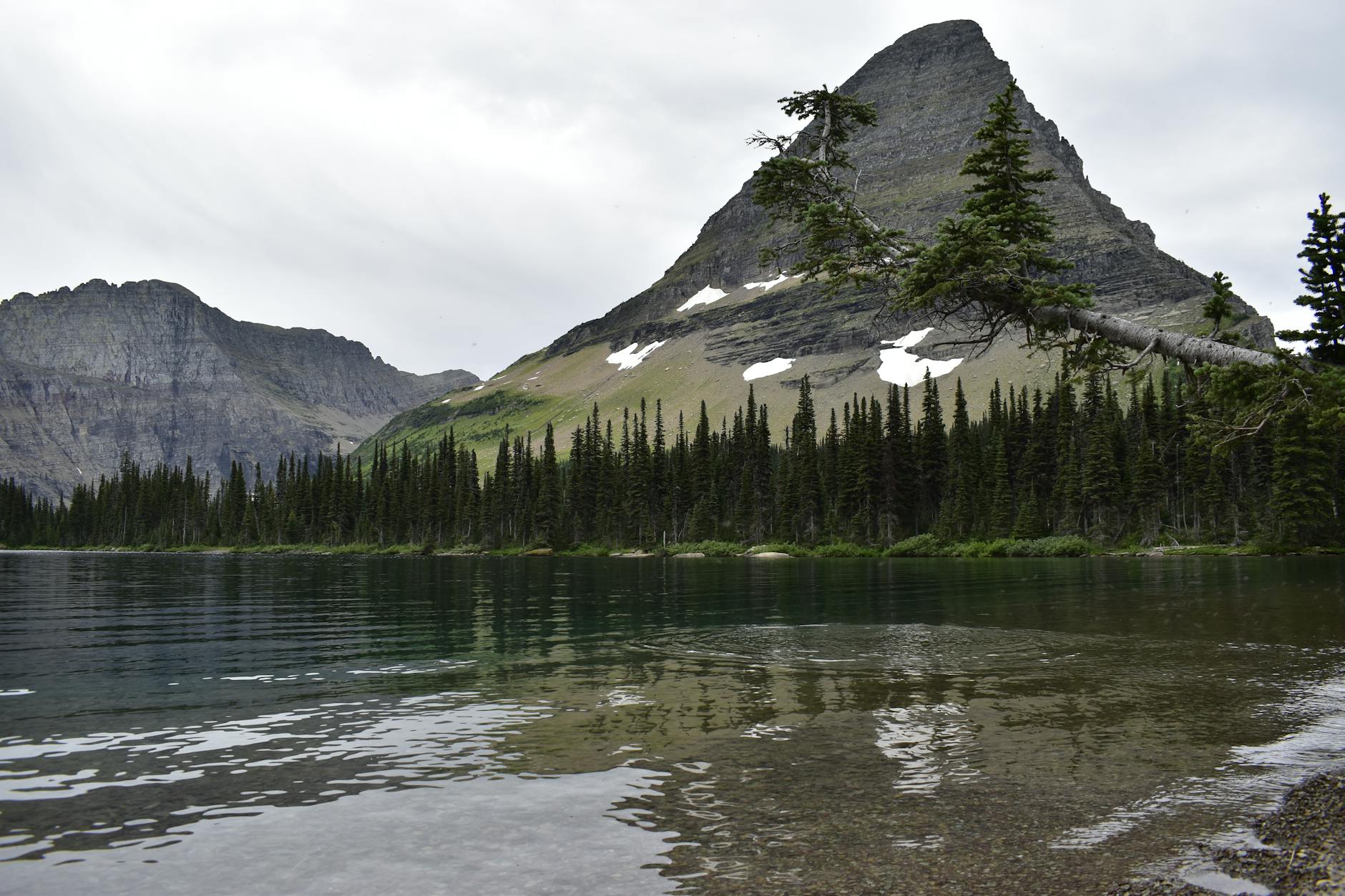 Capture the serene beauty of Glacier National Park's mountain landscape in Montana during summer.