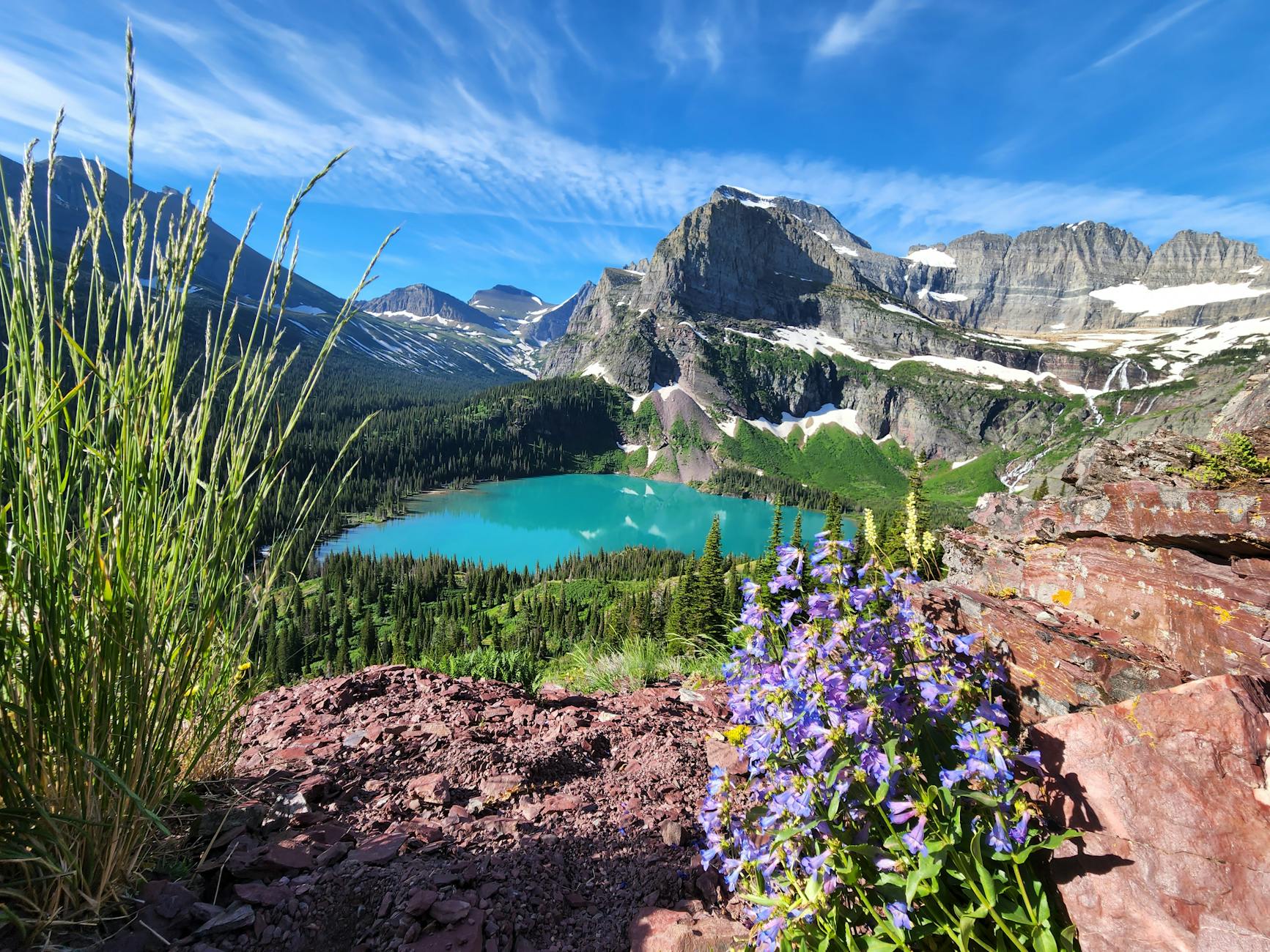 Breathtaking view of Emerald Lake surrounded by mountains in Glacier National Park, Montana.