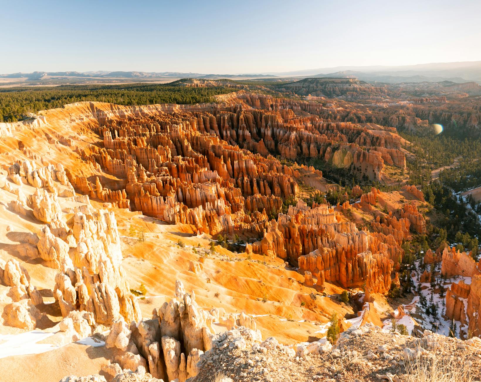 A breathtaking aerial view of Bryce Canyon National Park during sunrise, showcasing the unique rock formations.