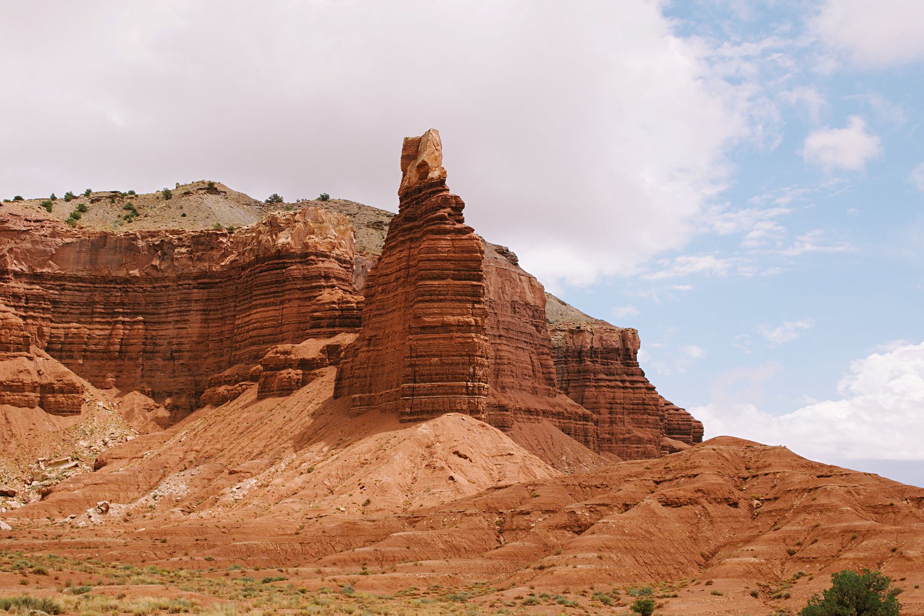 Stunning view of Chimney Rock in Capitol Reef, Utah under a bright sky.