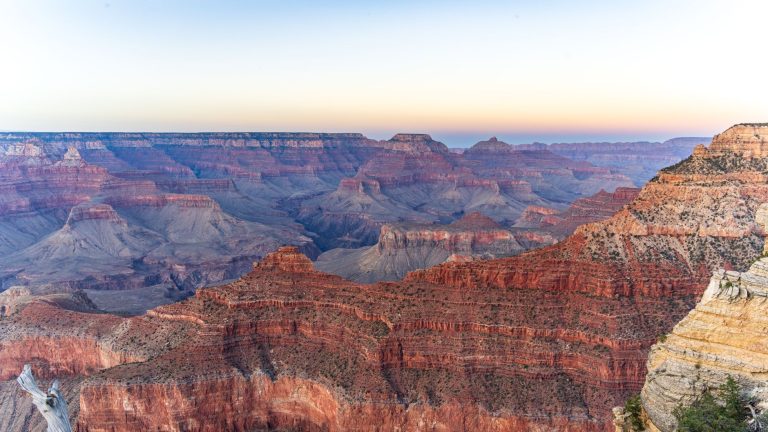 Experience the grandeur of the Grand Canyon with this stunning sunrise view from the South Rim.
