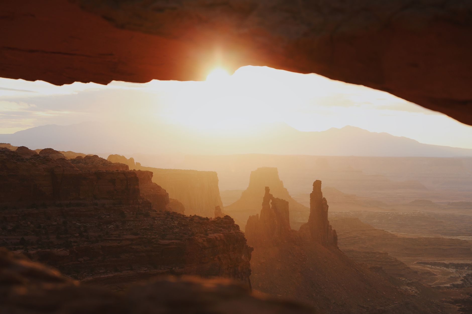 Stunning sunset view through Mesa Arch in Canyonlands National Park, Utah.