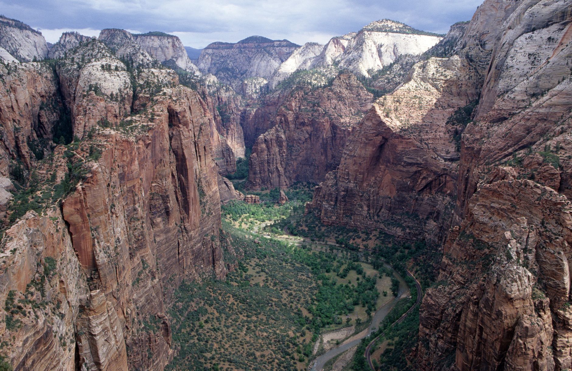 Majestic aerial shot of rocky cliffs and valley in Zion National Park, showcasing its natural beauty.